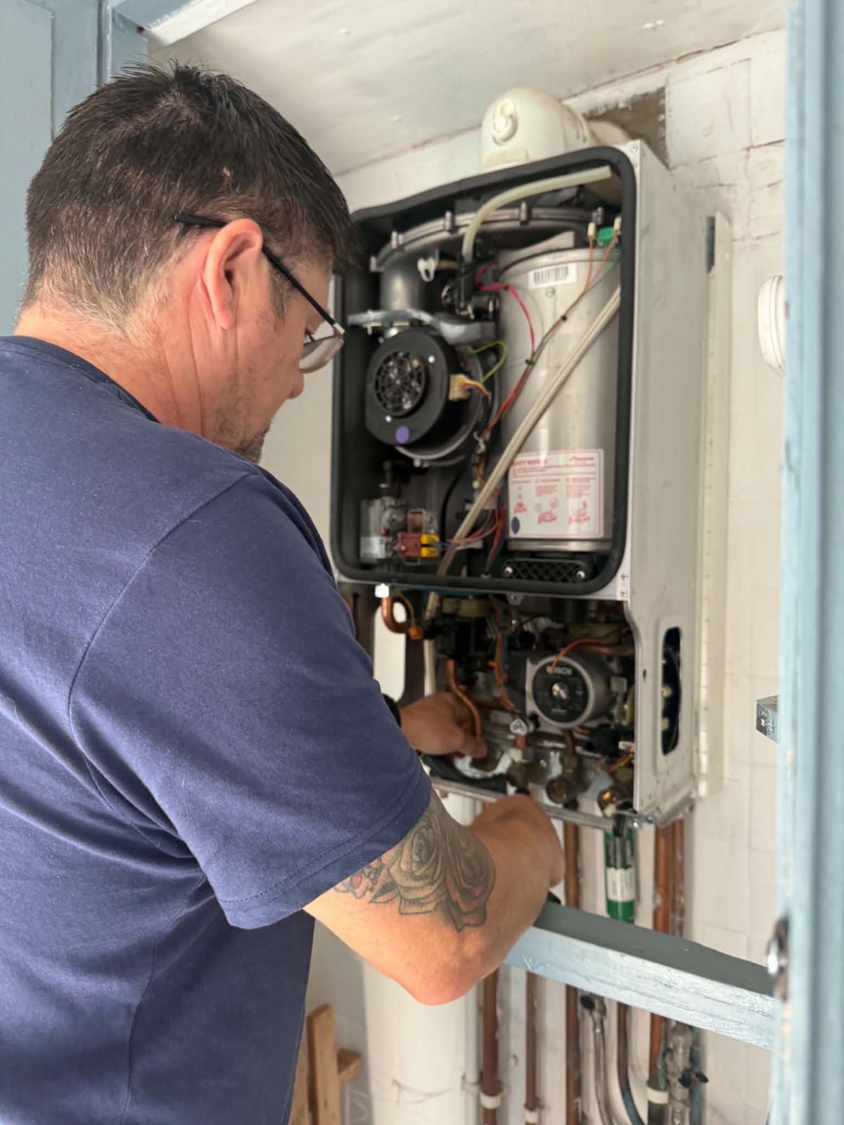 Mark servicing a boiler
